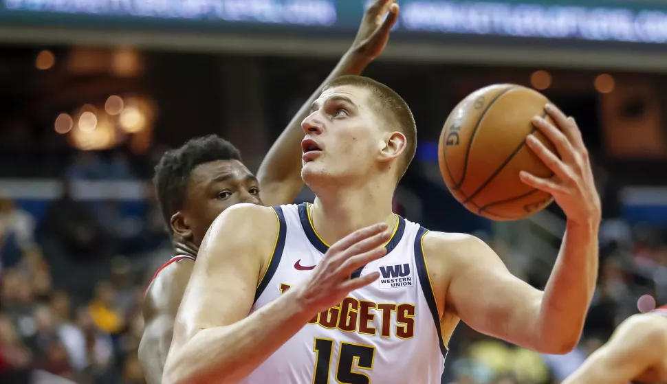 epa08505950 (FILE) - Denver Nuggets center Nikola Jokic (R) in action against Washington Wizards center Thomas Bryant (L) during the NBA basketball game between the Denver Nuggets and the Washington Wizards in Washington, DC, USA, 21 March 2019 (re-issued on 24 June 2020). Serbian basketball player Nikola Jokic of the Denver Nuggets was tested positive for the coronavirus COVID-19 disease, the Denver Post confirmed on late 23 June 2020. Jokic met Serbian tennis player Novak Djokovic during the Adria Tour tennis tournament in Belgrade. EPA/ERIK S. LESSER SHUTTERSTOCK OUT