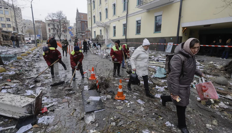 epa11786779 Ukrainian workers remove debris at the site of a missile strike in downtown Kyiv, Ukraine, 20 December 2024, amid the Russian invasion. At least one person was killed and 10 others injured as a result of Russian shelling in Kyiv, according to the State Emergency Service of Ukraine (SESU). EPA/SERGEY DOLZHENKO