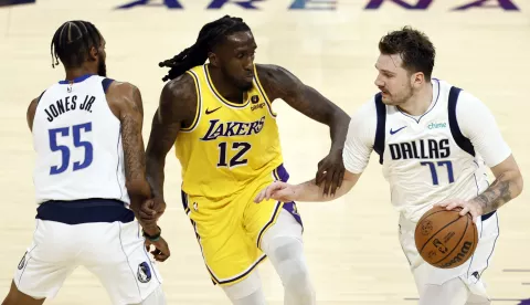 epa10990441 Dallas Mavericks forward-guard Luka Doncic (R) and forward Derrick Jones Jr. in action against Los Angeles Lakers forward Taurean Prince during the fourth quarter of the game between the Dallas Mavericks and the Los Angeles Lakers at Crypto.com Arena in Los Angeles, California, USA, 22 November 2023. EPA/ETIENNE LAURENT SHUTTERSTOCK OUT