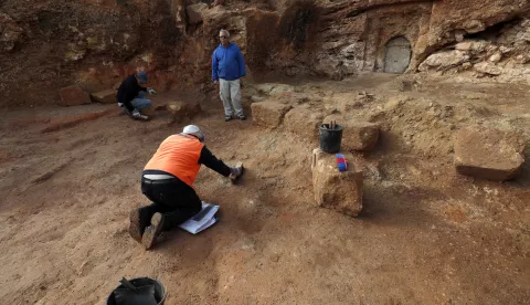 epa07466668 Israel Antiquities Authority employees work at burial estate from the Second Temple Period in the remains of a Jewish village from the Hasmonean period, approximately 2000 years old, uncovered in excavation at the Sharafat neighborhood of Jerusalem, 27 March 2019. Archaeologists from the Israel Antiquities Authority unearthed a large Hasmonean-era agricultural village including the remains of a large wine press, fragments of many storage jars, a large columbarium cave (rock-cut dovecote), olive press, a large ritual bath (miqveh), a water cistern, rock quarries and installations. A burial estate was also unearthed including a corridor leading to a large courtyard chiseled into the bedrock. EPA/ATEF SAFADI