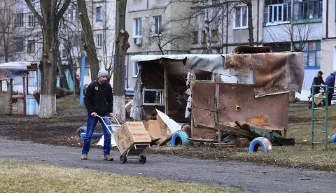 epa11137564 A resident of a small village near Kupiansk returns home as he holds food aid received from the NGO - Global Empowerment Mission (GEM) in Kupiansk, Kharkiv region, Ukraine, 08 February 2024, amid the Russian invasion. According to Ukrainian officials, Russian forces have been intensifying their offensive in the Kupiansk area of the front for more than six months as they try to regain control of the city since 2022, when Ukrainian forces recaptured control of the area in the Kharkiv counteroffensive. EPA/ANTONIO COTRIM