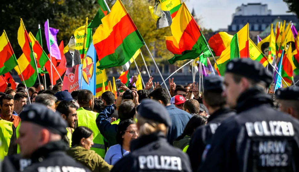 epa07005293 German police face Kurdish activists showing flags and shout slogans as they protest at the Rheinwiesen in Duesseldorf, Germany, 08 September 2018. More than 10,000 participants are expected to demand freedom for Abdullah Ocalan, one of founding members of the Kurdistan Workers' Party (PKK) which is banned in Germany. EPA/SASCHA STEINBACH