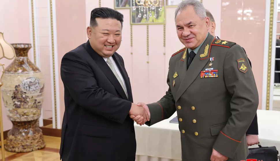 epa10770768 A photo released by the official North Korean Central News Agency (KCNA) shows North Korean Supreme Leader Kim Jong-un (L) shaking hands with Minister of Defense of the Russian Federation Sergei Shoigu (R) during a meeting at the office building of the Party Central Committee in Pyongyang, North Korea, 26 July 2023 (issued 27 July 2023). Shoigu is on a visit to North Korea coinciding with the nation's celebration of the armistice that ceased direct conflict in the 1950-53 Korean War. EPA/KCNA  EDITORIAL USE ONLY