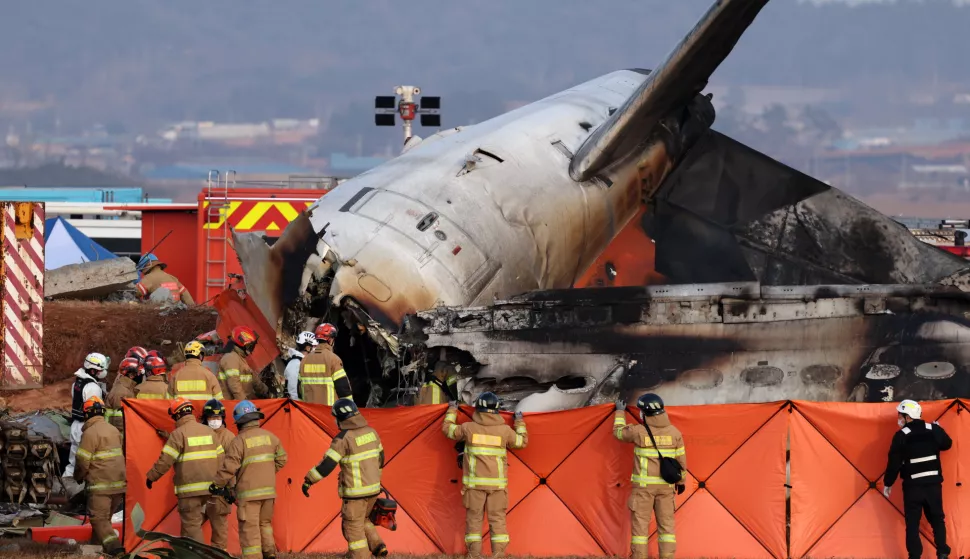 epa11797035 Firefighters search at the wreckage of the Jeju Air aircraft at Muan International Airport in Muan, 288 kilometers southwest of Seoul, South Korea, 29 December 2024. According to the National Fire Agency, a passenger jet carrying 181 people erupted in flames after going off the runway at an airport in South Korea's southwestern county of Muan on 29 December, leaving at least 176 people dead. EPA/HAN MYUNG-GU