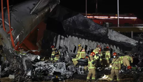 epa11797309 Firefighters work near the wreckage of a Jeju Air aircraft at Muan International Airport in Muan, South Jeolla Province, South Korea, 29 December 2024. According to the South Korea National Fire Agency (NFA), a passenger jet carrying 181 people erupted in flames after going off the runway at an airport in South Korea's southwestern county of Muan on 29 December, leaving at least 176 people dead and 3 missing, as two crew members survived. EPA/HAN MYUNG-GU