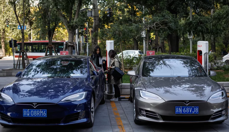 epa07295016 (FILE) - A woman unplugs her Tesla electric car from a charger at a charging station in Beijing, China, 23 October 2017 (reissued 18 January 2019). Tesla has issued a recall of more than 14,000 Model S cars in China after airbags were found to be fualty. EPA/ROMAN PILIPEY