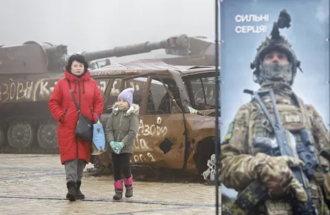 epa11766514 A woman and a child walk past destroyed Russian military machinery and damaged Ukrainian civilian vehicles displayed near St. Mykhailivsky Cathedral in downtown Kyiv, Ukraine, 09 December 2024, amid the ongoing Russian invasion. EPA/SERGEY DOLZHENKO 71058