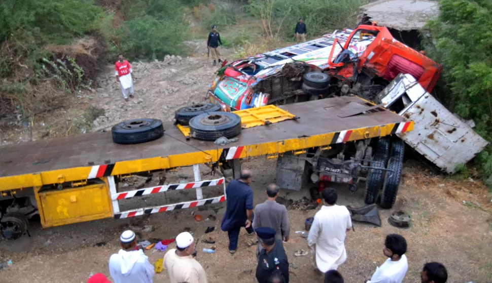epa06893399 Pakistani security officials inspect the scene of an accident involving a passenger bus and a truck in Matiari, Pakistan, 16 July 2018. At least 17 people were killed and 12 were injured when a passenger bus collided with a truck near Matiari. Reportedly, Pakistan has one of the highest traffic accident rates in the world owing to poor infrastructure and ill-maintained and overcrowded vehicles. EPA/NADEEM KHAWER