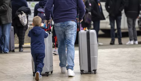 epa11797506 Flight passengers, with their luggage and ski bags, walk in front of terminal 2 of the Geneva Aeroport (GVA), in Geneva, Switzerland, 29 December 2024, as Christmas and New Year holiday travelers are crossing paths in Geneva this weekend. Thousands of skiers and tourists are expected this week at the airport, heading to ski resorts in Switzerland and France to celebrate the New Year. EPA/SALVATORE DI NOLFI