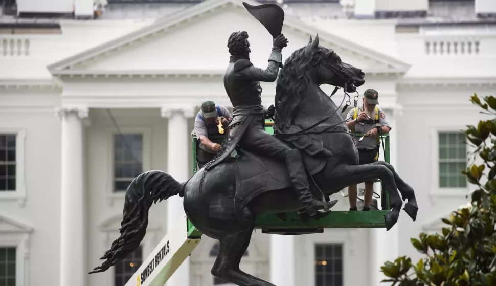 epaselect epa08479838 With the White House seen behind them, Randy Coy (L) and Gary Currens (R), staff in the monument division of Gettysburg National Military Park; heat the statue of Andrew Jackson at the Battle of New Orleans and apply microcrystalline wax to preserve the monument, as the US National Park Service performs bronze maintenance of monuments at Lafayette Park, in Washington, DC, USA, 11 June 2020. Lafayette Park, which is across the street from the White House, has reopened to the public with the removal of temporary fencing following protests over the death of George Floyd while in police custody in Minneapolis. Regularly scheduled bronze maintenance of the statues in Lafayette Park had been planned but additional work was required when graffiti was left on some of the monuments in the park. EPA/MICHAEL REYNOLDS