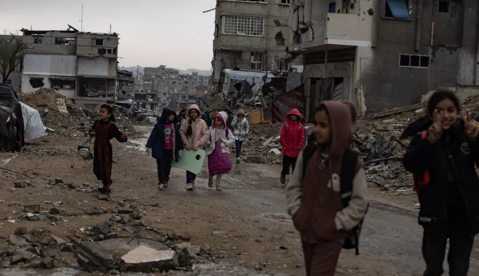 epa11799809 Palestinian children walk past their destroyed homes during heavy rains in Khan Yunis camp in the southern Gaza Strip, 31 December, 2024. According to the UN, at least 1.9 million people (or nine in ten people) across the Gaza Strip are internally displaced, including people who have been repeatedly displaced. Since October 2023, only about 11 percent of the Gaza Strip has not been placed under Israeli-issued evacuation orders, the UN aid coordination office OCHA said.&nbsp; EPA/HAITHAM IMAD