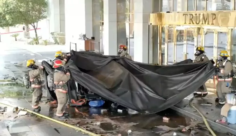 epa11802501 A frame grab taken from a drone video released by the Las Vegas Metropolitan Police Department (LVMPD) on 02 January 2025 shows firefighters removing a tarp after they extinguished a Tesla Cybertruck that exploded in front of the Trump Hotel in Las Vegas, Nevada, USA, 01 January 2025. According to authorities, the bed of the truck was filled with gas and fireworks. Law enforcement officials identified the driver, who was killed in the explosion, as Matthew Livelsberger. EPA/LAS VEGAS METROPOLITAN POLICE DEPARTMENT HANDOUT -- BEST QUALITY AVAILABLE --HANDOUT EDITORIAL USE ONLY/NO SALES