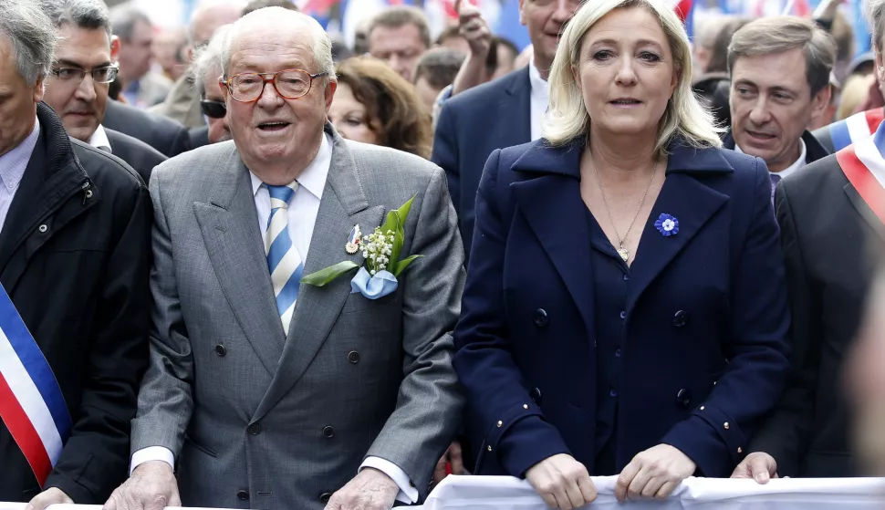 epa11811016 (FILE) - Former President of the Front National (FN) Jean-Marie Le Pen (L) and her daughter and actual President of the party Marine Le Pen (R) taking part in the party's traditional May Day rally in Paris, France, 01 May 2014 (re-issued 07 January 2025). Jean-Marie Le Pen has died on 07 January 2025 at the age of 96. EPA/YOAN VALAT