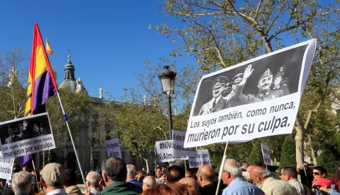 epa07865490 Protesters hold a banner with a picture of Spanish late dictator Francisco Franco (R) and German late dictator Adolf Hitler (L) that reads 'Their people also died because of their fault' during a protest at the Supreme Court in Madrid, Spain, to support the Government's decision of exhuming Franco's remains. The Supreme Court has endorsed a Royal Decree passed by the socialist Government, 24 August 2018, to modify the Spanish Historic Memory Law in order to allow the exhumation of Spanish dictator Francisco Franco's body from the memorial. El Valle de los Caidos is a controversial memorial complex that Franco decided to build back in 1940 to bury soldiers of the Nationalist faction fallen during the Civil War. It was years later, before its opening, when it was decided that soldiers from both sides should be buried at the memorial that was finally finished in 1959. Franco has been buried at the memorial since his death in 1975. According to the Supreme Court's ruling, Franco will have to be buried in a cemetery near Madrid, against his family's will that had the intention of burying him in the Spanish capital's city center. EPA/Fernando Alvarado