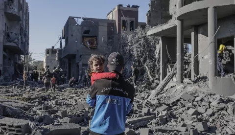 epa11803411 A Palestinian father carries his daughter next to the destroyed house of the Abu Libda family following an Israeli air strike in Al Maghazi refugee camp, central Gaza Strip, 03 January 2025. According to reports from the Ministry of Health in Gaza at least nine members of the Abu Libda family were killed following an Israeli air strike in the refugee camp. More than 45,500 Palestinians and over 1,400 Israelis have been killed, according to the Palestinian Health Ministry and the Israeli Army, since Hamas militants launched an attack against Israel from the Gaza Strip on 07 October 2023 and the Israeli operations in Gaza and the West Bank that followed it. EPA/MOHAMMED SABER