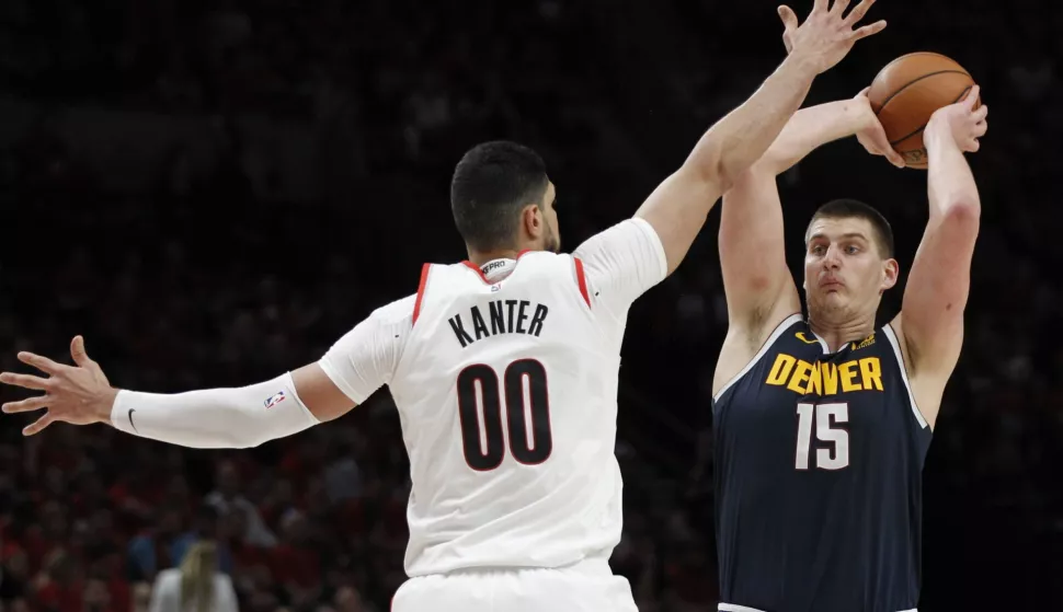 epa07550204 Denver Nuggets center Nikola Jokic (R) of Serbia looks to pass as Portland Trail Blazers center Enes Kanter (L) of Turkey defends during the NBA Western Conference second round playoff basketball game four between the Denver Nuggets and the Portland Trail Blazers at the Moda Center in Portland, Oregon, USA, 05 May 2019. EPA/STEVE DIPAOLA SHUTTERSTOCK OUT