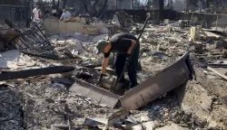 epa11817723 A person, who requested not be identified, sorts through the remains of his mother's home in Altadena, California, USA, 10 January 2025. Multiple wildfires continue to burn across thousands of acres in Southern California, destroying thousands of homes and forcing people to evacuate areas throughout the Los Angeles area. According to the California Governor's office, more than 7,500 firefighting and emergency personnel are involved in response efforts. EPA/CAROLINE BREHMAN