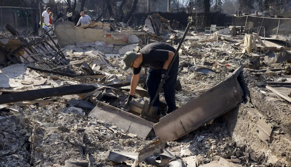 epa11817723 A person, who requested not be identified, sorts through the remains of his mother's home in Altadena, California, USA, 10 January 2025. Multiple wildfires continue to burn across thousands of acres in Southern California, destroying thousands of homes and forcing people to evacuate areas throughout the Los Angeles area. According to the California Governor's office, more than 7,500 firefighting and emergency personnel are involved in response efforts. EPA/CAROLINE BREHMAN