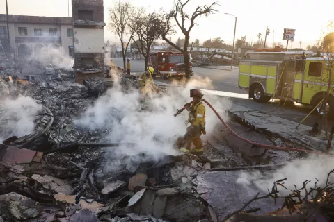 epa11817712 Firefighters hose down the burning remains of a structure in Altadena, California, USA, 10 January 2025. Multiple wildfires continue to burn across thousands of acres in Southern California, destroying thousands of homes and forcing people to evacuate areas throughout the Los Angeles area. According to the California Governor's office, more than 7,500 firefighting and emergency personnel are involved in response efforts. EPA/CAROLINE BREHMAN