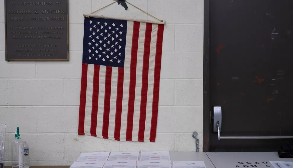 epa10294949 An American flag hangs above ballots at the Boyle Heights Senior Center in Los Angeles, California, USA, 08 November 2022. The US midterm elections are held every four years at the midpoint of each presidential term and this year include elections for all 435 seats in the House of Representatives, 35 of the 100 seats in the Senate and 36 of the 50 state governors as well as numerous other local seats and ballot issues. EPA/ALLISON DINNER