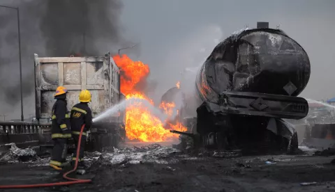 epa08500844 Firefighters spray water to extinguish a fire at the site of an accident after multiple fuel tankers spilled their cargo on a bridge along Lagos-Ibadan expressway in Lagos, Nigeria, 21 June 2020. Two people were reported dead in the overnight fire involving multiple fuel tankers. Oil tanker accident is a common phenomenon in a city of about 21 million people. EPA/AKINTUNDE AKINLEYE