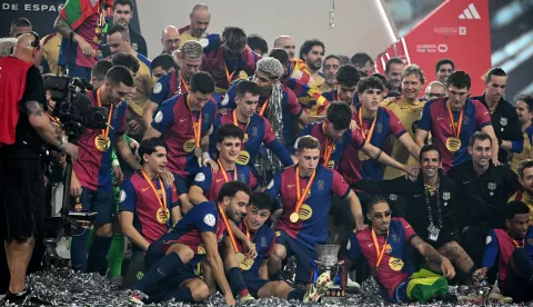 epa11820938 Players of Barcelona celebrate with the trophy after winning the final of the Spanish Super Cup, the Supercopa de Espana, between Real Madrid and FC Barcleona in Jeddah, Saudi Arabia, 12 January 2025. EPA/STR