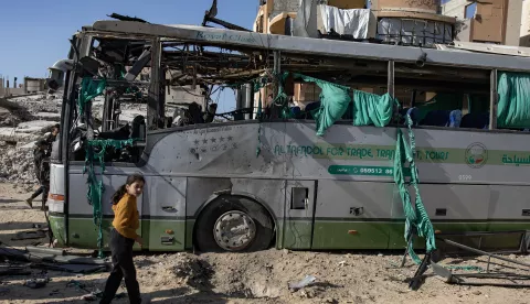 epa11791012 Palestinians inspect a bus hit by an Israeli airstrike in Khan Yunis, southern Gaza Strip, 23 December 2024. At least two people were injured in an Israeli airstrike on a bus in Khan Yunis, according to medics at Nasser Hospital. More than 45,000 Palestinians and over 1,400 Israelis have been killed, according to the Palestinian Health Ministry and the Israeli Army, since Hamas militants launched an attack against Israel from the Gaza Strip on 07 October 2023, and the Israeli operations in Gaza and the West Bank which followed it. EPA/HAITHAM IMAD