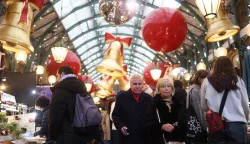 epa11782431 Shoppers walk past decorations for the upcoming Christmas holiday, at a store in London, Britain, 17 December 2024. EPA/NEIL HALL