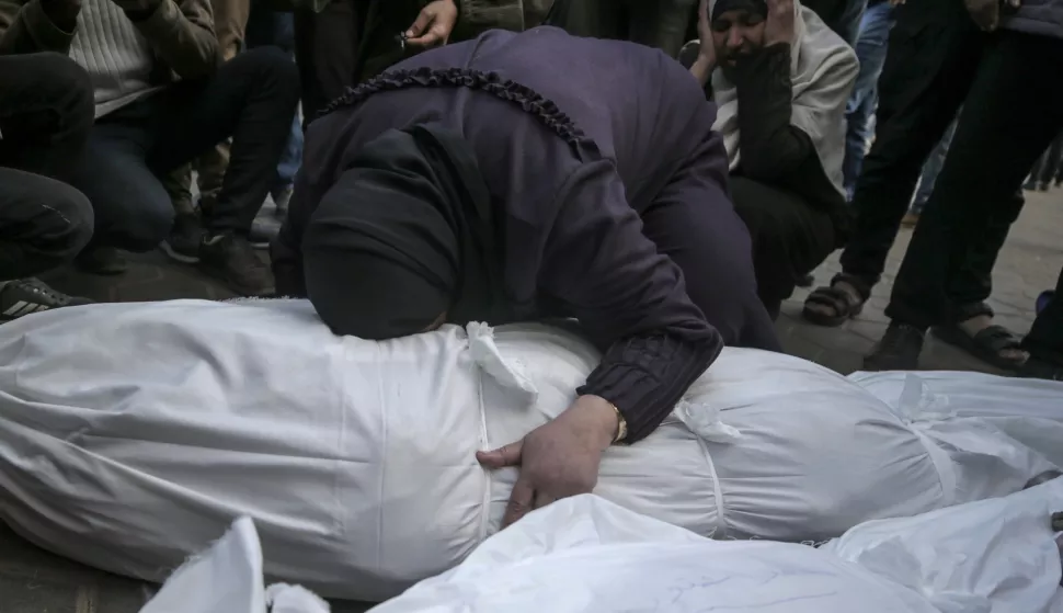 epa11825824 Palestinian women mourn over the covered bodies of the members of a Palestinian family killed in an Israeli airstrike, at Al Aqsa Martyrs Hospital in Deir Al Balah town, central Gaza Strip, 15 January 2025. According to the Palestinian Ministry of Health in Gaza, at least 11 Palestinians were killed following an overnight Israeli airstrike in Deir Al Balah, central Gaza. More than 46,500 Palestinians and over 1,400 Israelis have been killed, according to the Palestinian Health Ministry and the Israeli Army, since Hamas militants launched an attack against Israel from the Gaza Strip on 07 October 2023, and the Israeli operations in Gaza and the West Bank which followed it. EPA/MOHAMMED SABER