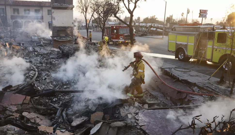 epa11817712 Firefighters hose down the burning remains of a structure in Altadena, California, USA, 10 January 2025. Multiple wildfires continue to burn across thousands of acres in Southern California, destroying thousands of homes and forcing people to evacuate areas throughout the Los Angeles area. According to the California Governor's office, more than 7,500 firefighting and emergency personnel are involved in response efforts. EPA/CAROLINE BREHMAN