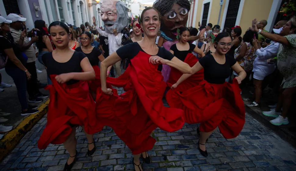 epa11829600 Dancers participate in the 55th Fiestas de la Calle San Sebastian in San Juan, Puerto Rico, 16 January 2025. Crowds celebrated at the Fiestas de la Calle San Sebastian parade in Old San Juan, where traditional Puerto Rican music filled the air as the festival honored legendary local rapper Vico C (Luis Armando Lozada). EPA/THAIS LLORCA