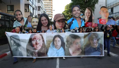 epa11812607 Families of hostages held by Hamas in Gaza and their supporters carry pictures of the hostages during a protest calling for a ceasefire and for the release of hostages, outside the Likud party headquarters in Tel Aviv, Israel, 08 January 2025. According to the Israeli army (IDF) spokesperson, around 100 Israeli hostages remain in captivity in the Gaza Strip, including the bodies of at least 33 confirmed dead. EPA/ABIR SULTAN