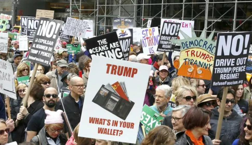 epa05910137 Protesters march toward Trump Tower calling for US President Donald J. Trump to release his tax returns to the public in New York, New York, USA, 15 March 2017. Traditionally 15 April is the day US federal income taxes are due unless the date falls on a weekend. Similar protests were planned in cities across the country. EPA/JASON SZENES