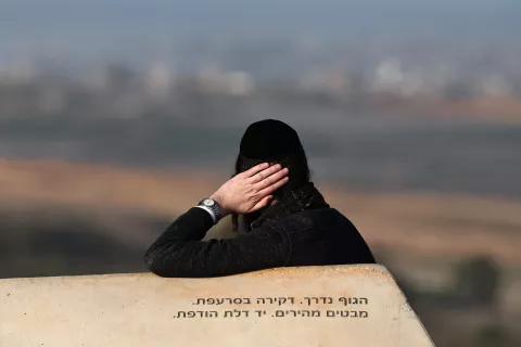 epa11835452 An Israeli Ultra-Orthodox man sits in an area overlooking the northern Gaza Strip, at the Israeli-Gaza border near Sderot, southern Israel, 19 January 2025, before a ceasefire in Gaza is set to come into effect. Israel and Hamas agreed on a hostage release deal and a Gaza ceasefire to be implemented on 19 January 2025. More than 46,000 Palestinians have been killed in the Gaza Strip, according to the Palestinian Ministry of Health, since Israel launched a military campaign in the strip in response to a cross-border attack led by the Palestinian militant group Hamas on 07 October 2023, in which about 1,200 Israelis were killed and more than 250 taken hostage. EPA/ATEF SAFADI