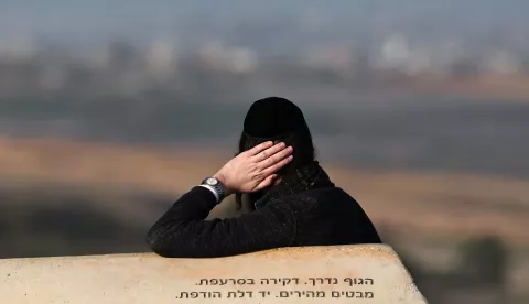 epa11835452 An Israeli Ultra-Orthodox man sits in an area overlooking the northern Gaza Strip, at the Israeli-Gaza border near Sderot, southern Israel, 19 January 2025, before a ceasefire in Gaza is set to come into effect. Israel and Hamas agreed on a hostage release deal and a Gaza ceasefire to be implemented on 19 January 2025. More than 46,000 Palestinians have been killed in the Gaza Strip, according to the Palestinian Ministry of Health, since Israel launched a military campaign in the strip in response to a cross-border attack led by the Palestinian militant group Hamas on 07 October 2023, in which about 1,200 Israelis were killed and more than 250 taken hostage. EPA/ATEF SAFADI