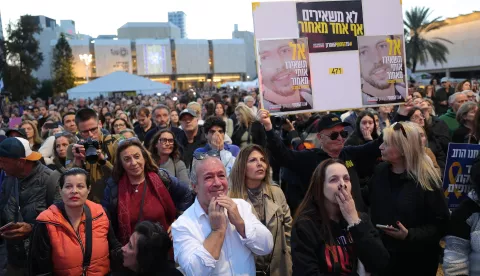 epa11836679 People watch a live stream on big screen that reports on the release of three Israeli female hostages, Romi Gonen, Emily Damari and Doron Steinbrecher transferred from Hamas to the Red Cross in hostages square, outside of the Kirya military base, as the ceasefire in Gaza comes into effect, in Tel Aviv, Israel, 19 January 2025. Israel and Hamas agreed on a hostage release deal and a Gaza ceasefire to be implemented on 19 January 2025. More than 46,000 Palestinians have been killed in the Gaza Strip, according to the Palestinian Ministry of Health, since Israel launched a military campaign in the strip in response to a cross-border attack led by the Palestinian militant group Hamas on 07 October 2023, in which about 1,200 Israelis were killed and more than 250 taken hostage. EPA/ABIR SULTAN