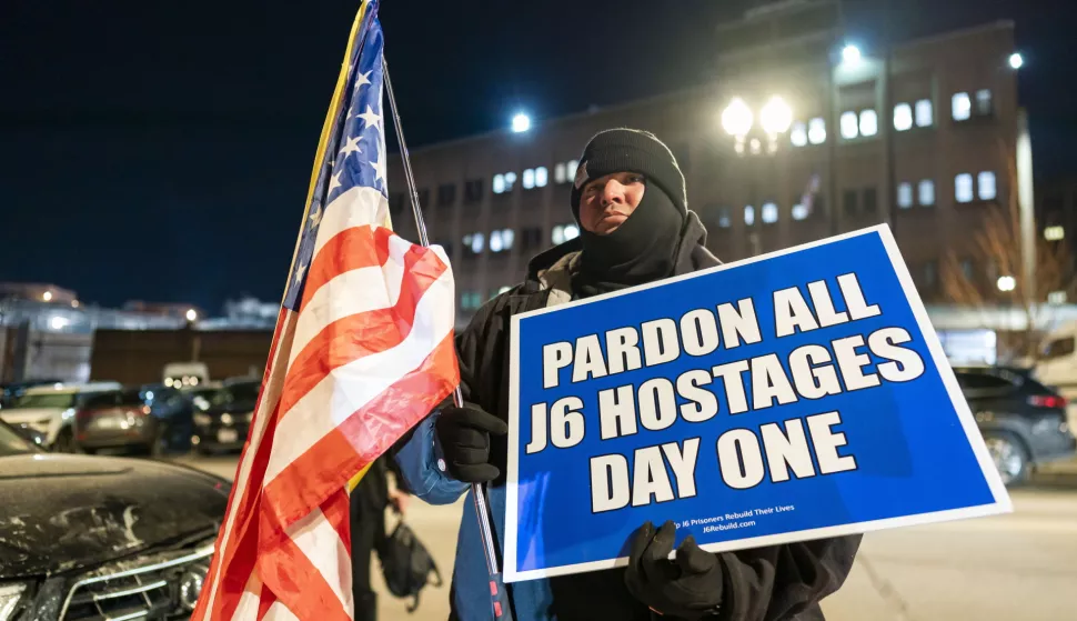 epa11840825 A man holds a placard and the American flag outside the DC Central Detention Facility, commonly known as the DC Jail, in anticipation of a potential pardon by U.S. President Donald Trump for individuals convicted in connection with the January 6, 2021 attack on the United States Capitol, in Washington, DC, USA, 20 January 2025. Trump, on 20 January, issued pardons for more than 1,000 people convicted for their roles in the January 6 Capitol riot. EPA/WILL OLIVER