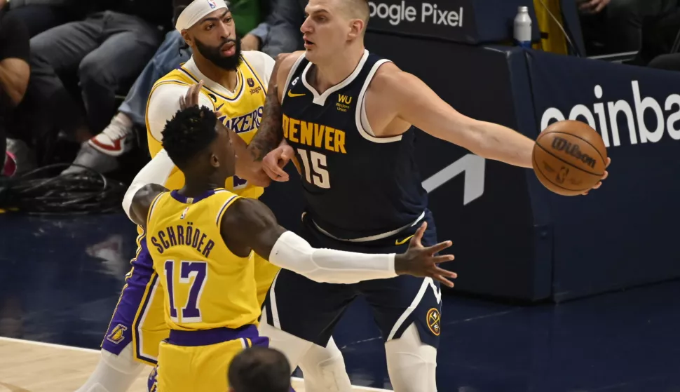 epa10638029 Denver Nuggets center Nikola Jokic of Serbia (R) tries to pass the ball past Los Angeles Lakers forward Anthony Davis (C) and Los Angeles Lakers guard Dennis Schroder (L) during the second quarter of game two of the NBA Western Conference finals series between the Los Angeles Lakers and the Denver Nuggets at Ball Arena in Denver, Colorado, 18 May 2023. The series is the best of seven games. EPA/BOB PEARSON SHUTTERSTOCK OUT