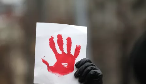 epaselect epa11792951 A protestor holds a banner depicting a red bloodied hand during a protest rally in Belgrade, Serbia, 25 December 2024. University students called on a protest asking for accountability of the Prosecutor General Zagorka Dolovac after fifteen people lost their lives in the collapse of the Novi Sad Railway Station canopy on 01 November 2024. The station building, which had been renovated and reopened on 05 July 2024, was undergoing further renovations shortly before the collapse. EPA/ANDREJ CUKIC