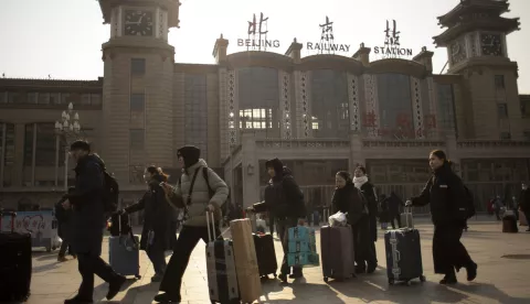 epaselect epa11849002 Travelers walk with their suitcases outside a train station in Beijing, China, 24 January 2025. The Chinese Lunar New Year for 2025, representing the year of the Snake, falls on 29 January and local officials expect 9 billion trips during the 'Chunyun', the travel rush between 14 January and 22 February. EPA/ANDRES MARTINEZ CASARES