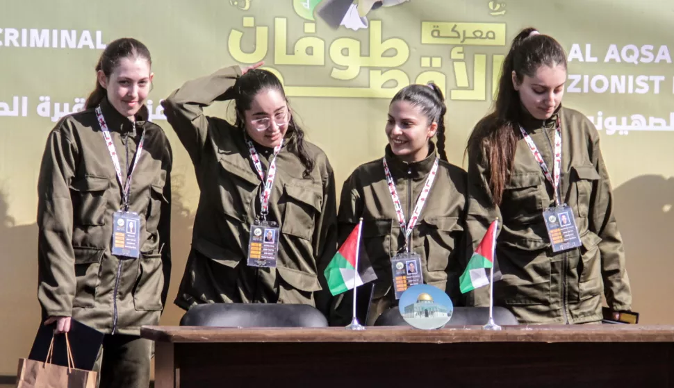 epa11851278 (L-R) Israeli hostages Naama Levy, Liri Albag, Daniella Gilboa and Karina Ariev stand on a stage before being delivered to the representative of the International Committee of the Red Cross (ICRC) by Hamas militants, as they are released from the Gaza Strip, in Gaza City, 25 January 2025. The four Israeli hostage soldiers Liri Albag, Naama Levy, Karina Ariev, and Daniella Gilboa, were taken hostage from an intelligence outpost near the Israeli Gaza border during the Hamas-led attack on 07 October 2023. Israel and Hamas implemented the first phase of a hostage release and ceasefire deal on 19 January 2025. EPA/MAHMOUD ZAKI