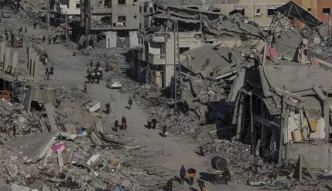 epa11840331 Internally displaced Palestinians walk along a street among the rubble of destroyed buildings amid a ceasefire between Israel and Hamas, in Rafah, southern Gaza Strip, 20 January 2025. Israel and Hamas implemented the first phase of a hostage release and ceasefire deal on 19 January 2025. More than 46,000 Palestinians have been killed in the Gaza Strip, according to the Palestinian Ministry of Health, since Israel launched a military campaign in the strip in response to a cross-border attack led by the Palestinian militant group Hamas on 07 October 2023, in which about 1,200 Israelis were killed and more than 250 taken hostage. EPA/MOHAMMED SABER