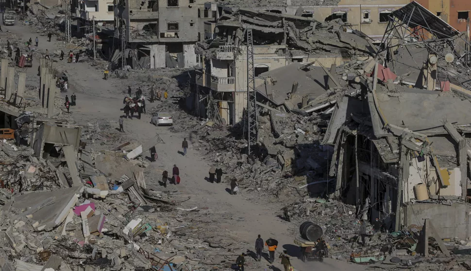 epa11840331 Internally displaced Palestinians walk along a street among the rubble of destroyed buildings amid a ceasefire between Israel and Hamas, in Rafah, southern Gaza Strip, 20 January 2025. Israel and Hamas implemented the first phase of a hostage release and ceasefire deal on 19 January 2025. More than 46,000 Palestinians have been killed in the Gaza Strip, according to the Palestinian Ministry of Health, since Israel launched a military campaign in the strip in response to a cross-border attack led by the Palestinian militant group Hamas on 07 October 2023, in which about 1,200 Israelis were killed and more than 250 taken hostage. EPA/MOHAMMED SABER