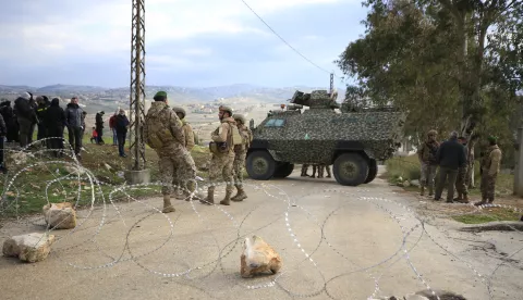 epa11854830 Soldiers and civilians stand at a Lebanese army checkpoint along a road leading to their village, in Meiss al-Jabal, Marjayoun District, southern Lebanon, 26 January 2025. According to the Lebanese Ministry of Health more than a dozen people were killed when the Israeli army reportedly fired at Lebanese attempting to return to their villages in southern Lebanon. EPA/STR