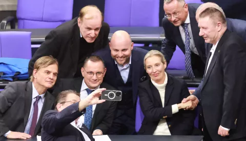 epa11860958 Alternative for Germany (AfD) party Members of Parliament stand around Alternative for Germany (AfD) party and faction co-chairwoman Alice Weidel (C-R) and Alternative for Germany (AfD) party and faction co-chairman Tino Chrupalla (C-L) as they pose for a selfie after a motion of the Christian Democratic Union (CDU) won a majority during a session of the German parliament 'Bundestag' in Berlin, Germany, 29 January 2025. One of the main topics of session of the Bundestag is the delivery of a government statement by German Chancellor Olaf Scholz on current domestic policy issues. EPA/CLEMENS BILAN