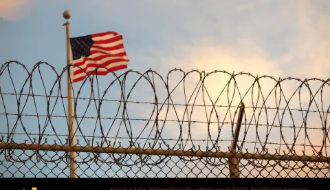 16 October 2018, Cuba, Guantanamo Bay: A US-American flag blows behind a barbed wire fence in the wind. The infamous camp has now existed for almost 17 years. 40 inmates are still being held there. (to dpa "The aging prisoners of Guantánamo Bay" of 27.11.2018) Photo: Maren Hennemuth/dpa /DPA/PIXSELL