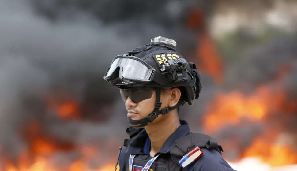 epa10714626 A Cambodian officer stands guard during a drug destruction event in Phnom Penh, Cambodia, 28 June 2023. The Cambodian National Authority for Combating Drugs destroyed nearly six tons of illegal drug substance ingredients in an effort to fight against drug production, distribution and drug trafficking. EPA/KITH SEREY