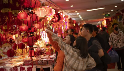 epa11844168 People check decorations on sale inside a store at a mall in Beijing, China, 22 January 2025. The Chinese Lunar New Year in 2025 falls on 29 January, and this year will be the Year of the Snake. EPA/ANDRES MARTINEZ CASARES