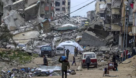 epa11880832 Palestinians walk between destroyed houses in Al Shatea refugee camp amid a ceasefire between Israel and Hamas, in Gaza City, Gaza Strip, 07 February 2025. Israel and Hamas implemented the first phase of a hostage release and ceasefire deal on 19 January 2025. More than 46,000 Palestinians have been killed in the Gaza Strip, according to the Palestinian Ministry of Health, since Israel launched a military campaign in the strip in response to a cross-border attack led by the Palestinian militant group Hamas on 07 October 2023, in which about 1,200 Israelis were killed and more than 250 taken hostage. EPA/MOHAMMED SABER