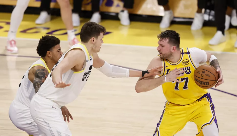epa11887384 Los Angeles Lakers guard Luka Doncic (R) protects the ball from Utah Jazz center Walker Kessler (L) and Utah Jazz guard Keyonte George (C) from during the third quarter of the NBA basketball game between the Utah Jazz and Los Angeles Lakers in Los Angeles, California, USA, 10 February 2025. EPA/CAROLINE BREHMAN SHUTTERSTOCK OUT